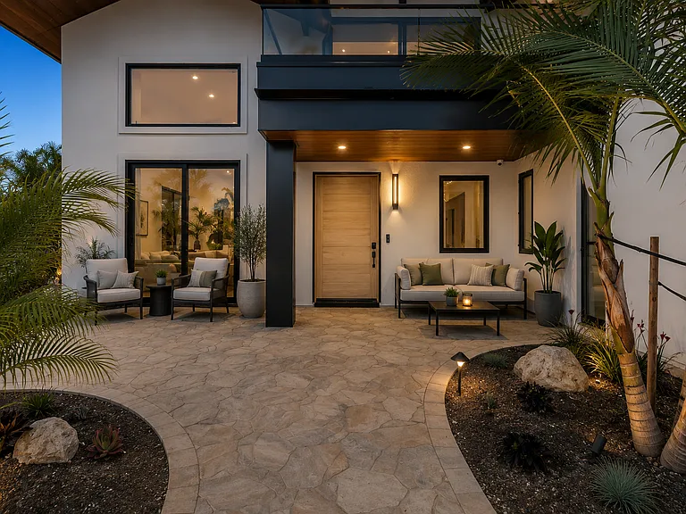 The front entry way has areas for lounge, paved areas surrounded by pet safe landscaping.