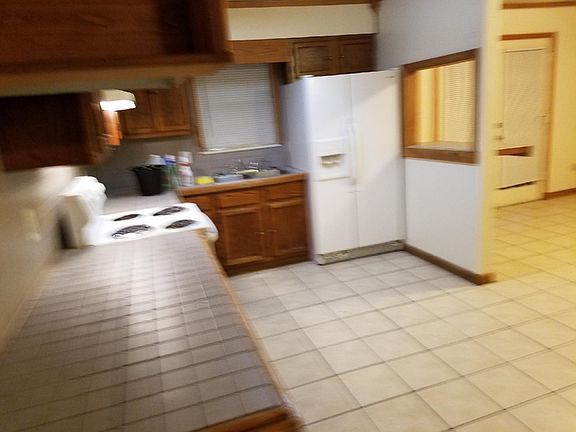 Kitchen and eating area with tile floor