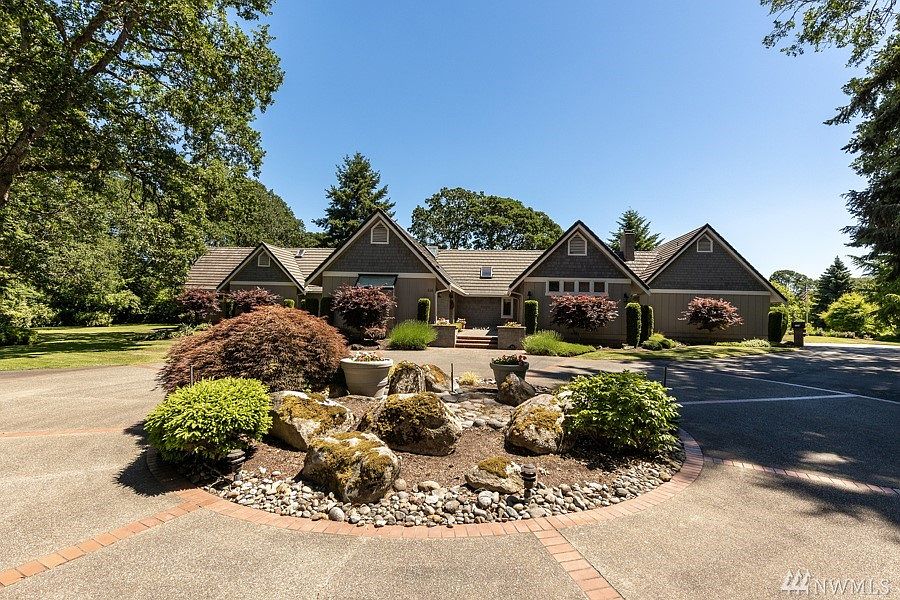 Tacoma Country and Golf Club Estate on 1.8 acres with views of the 14th tee, circular driveway, attached 2 car garage, and detached 4 car garage. 