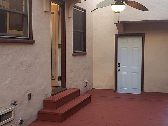 Side patio looking in at the back door to the house (kitchen) and door to the garage