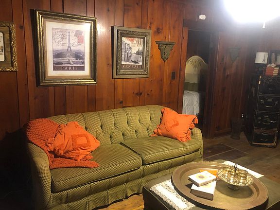 The living room features this 6 foot long sofa which is extremely comfortable. Feel free to remove the gold tray and put your feet up on the oversized ottoman. Guests love this beautiful room. Everyone is surprised to see a home in the city that is mad