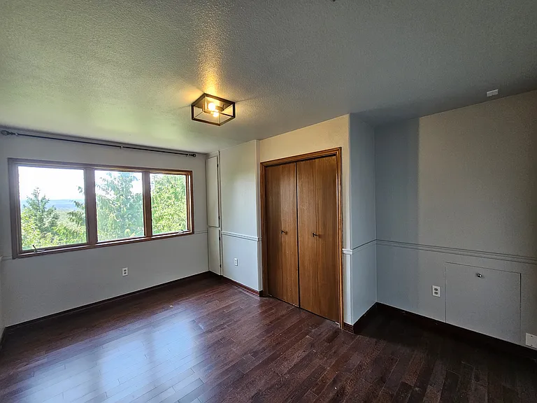 Upstairs bedroom 2 with built-ins and ample closet space.