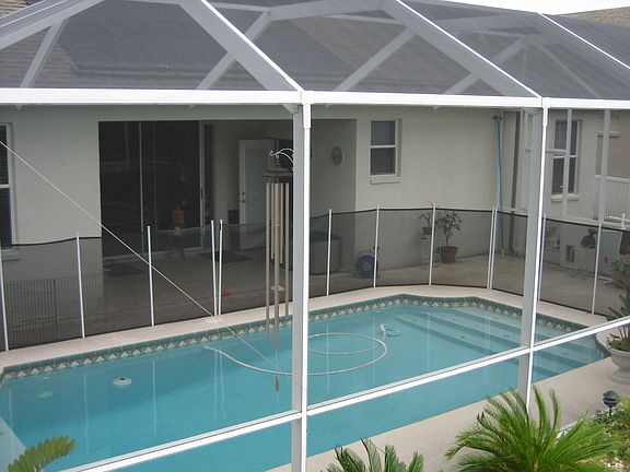 A covered lanai opens into screened pool.