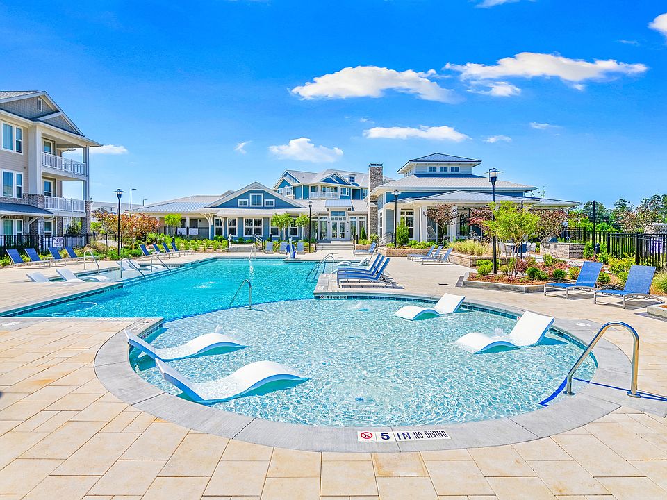 Resort-style swimming pool with in-water lounge chairs