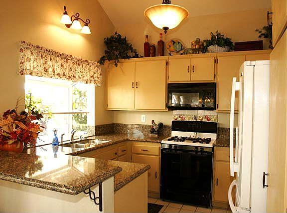 Kitchen with granite countertops and new light fixtures
