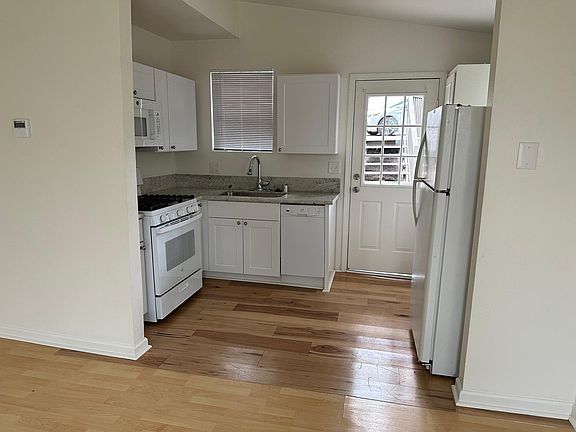 Kitchen with Dishwasher and Refrigerator (floor has recently been updated to tile)