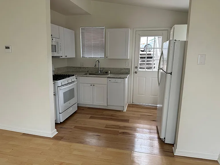 Kitchen with Dishwasher and Refrigerator (floor has recently been updated to tile)
