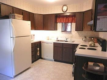 Kitchen offers electric range, refrigerator, dishwasher & disposal