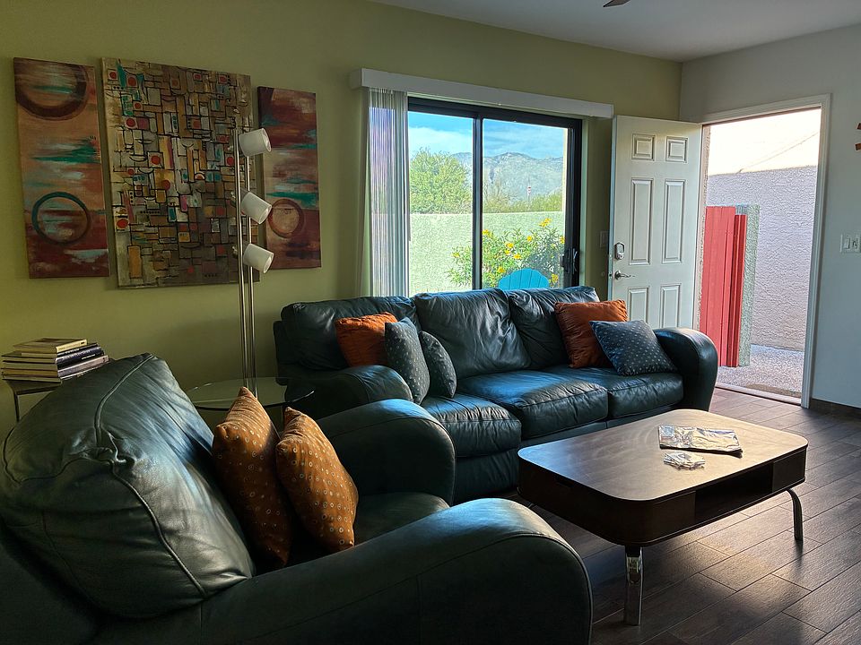 Living room, showing front door and one of two sliding glass doors leading to walled in backyard.