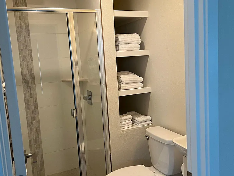 Master bedroom in-suite bathroom with walk-in shower, rain water head, heated floor, medicine cabinet, and automatic exhaust fan.