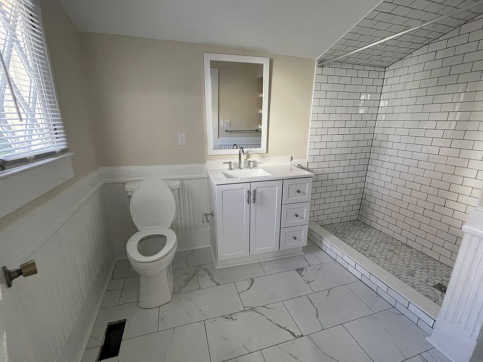 Newly tiled bathroom with walk-in shower.
