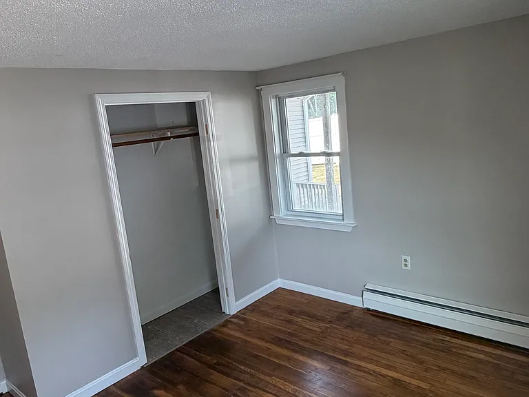 one of two bedrooms with hardwood floors