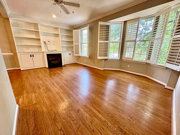 Spacious, sun-filled living area with hardwood floors.