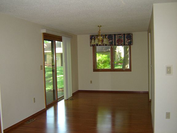The dining room is an extension of the living room, giving a spacious feel to this whole area.  Wood floors are also in this area.  Notice the patio door leading to back yard.