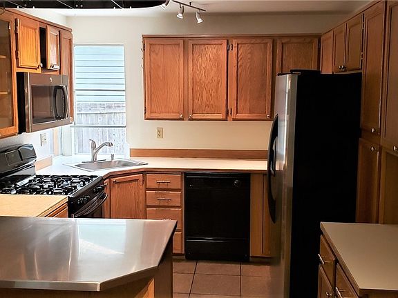 Full kitchen with lots of cabinets.