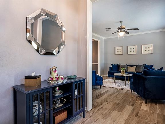 Upon entering this home, you step into the cozy foyer flanked by adjoining living room/flex room with beautiful wood tile floors!