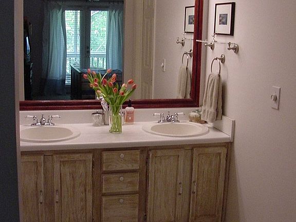 Master bath features double sinks, separate water closet & updated tile floors