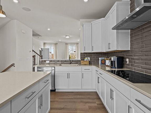 Gourmet kitchen with quartz counter tops, electric cooktop and vented hood, by DRB Homes Charlotte,