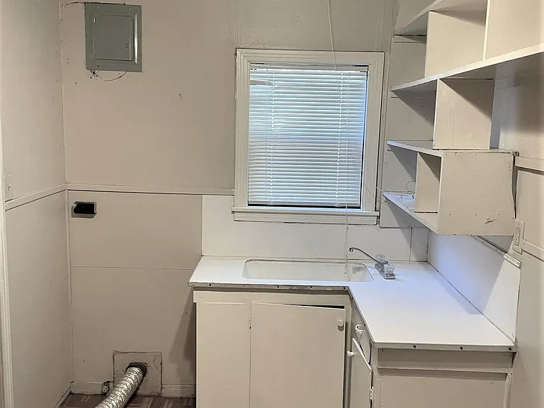 Huge utility room with cabinets and shelves plus room for a 2nd refrigerator