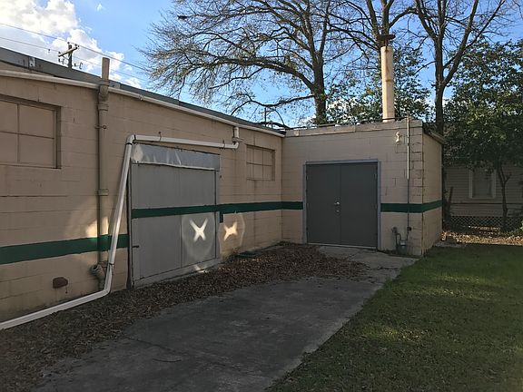 Back w/concrete patio and storage