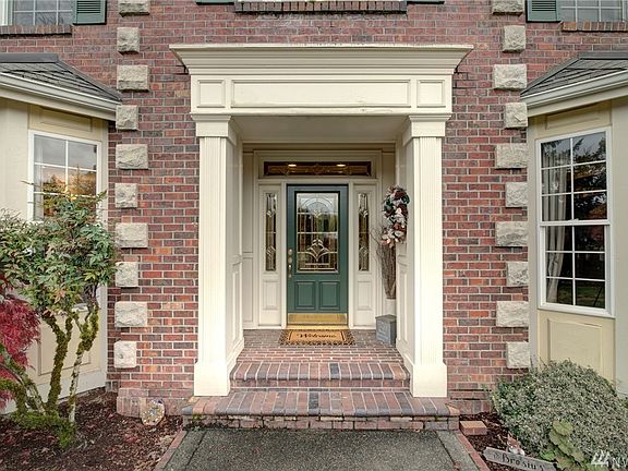 The vestibule is flanked by columns with a beautifully detailed header and surround by brickwork with cornerstone detail. 