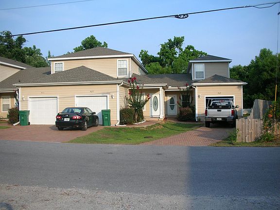 This is a view of the front of 511 31st Street. The townhome is to the left of the black car.