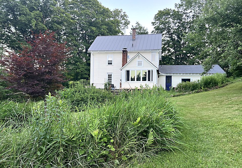 View of house from the north. Irises bloom in spring, day lilies bloom in summer