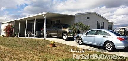 FRONT OF HOUSE. LONG DRIVE & CARPORT
						:
						Large home on corner lot with lake views, long driveway and covered carport.
