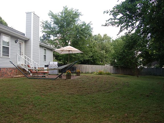 The backyard is bordered by the fencerow of an old farm.