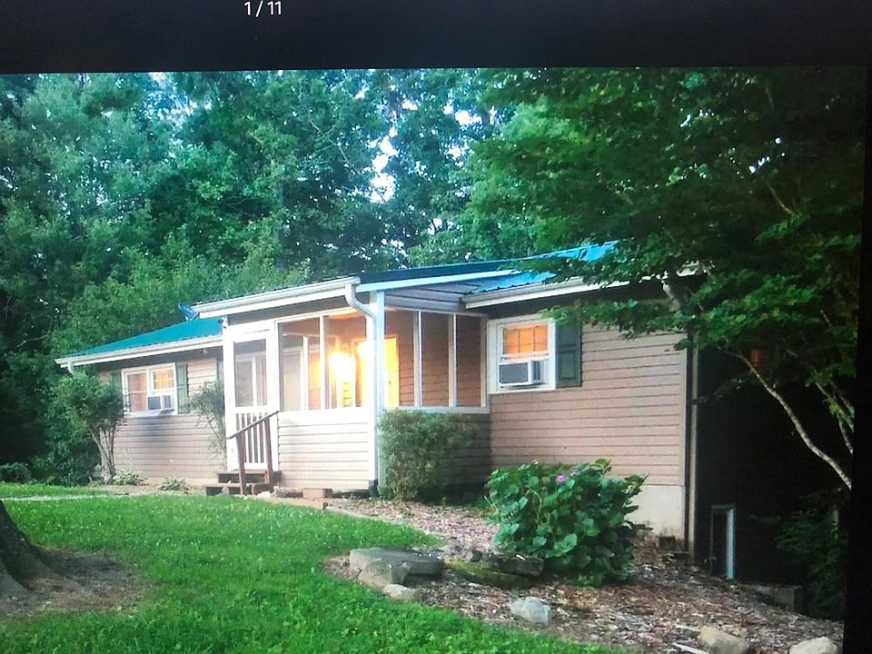 Front view of house and screened porch.
