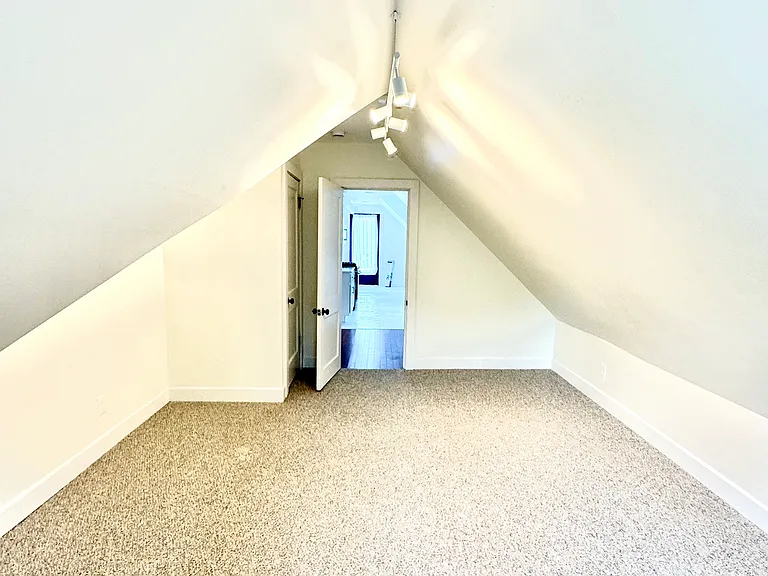 Bedroom #2, looking out into adjacent Kitchen area