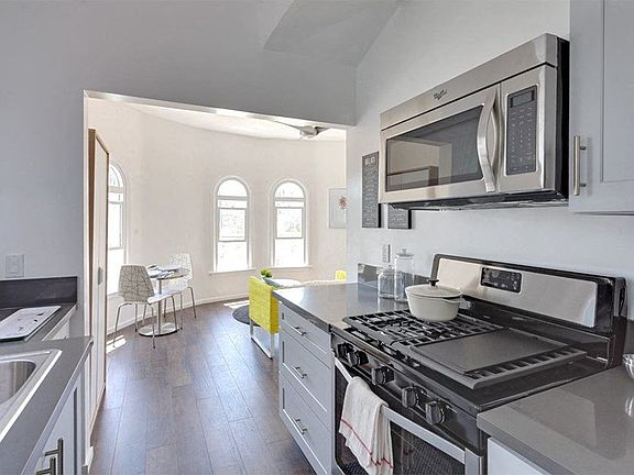 Kitchen view looking into bright dining area.