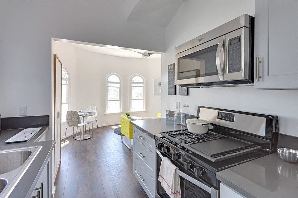 Kitchen view looking into bright dining area.