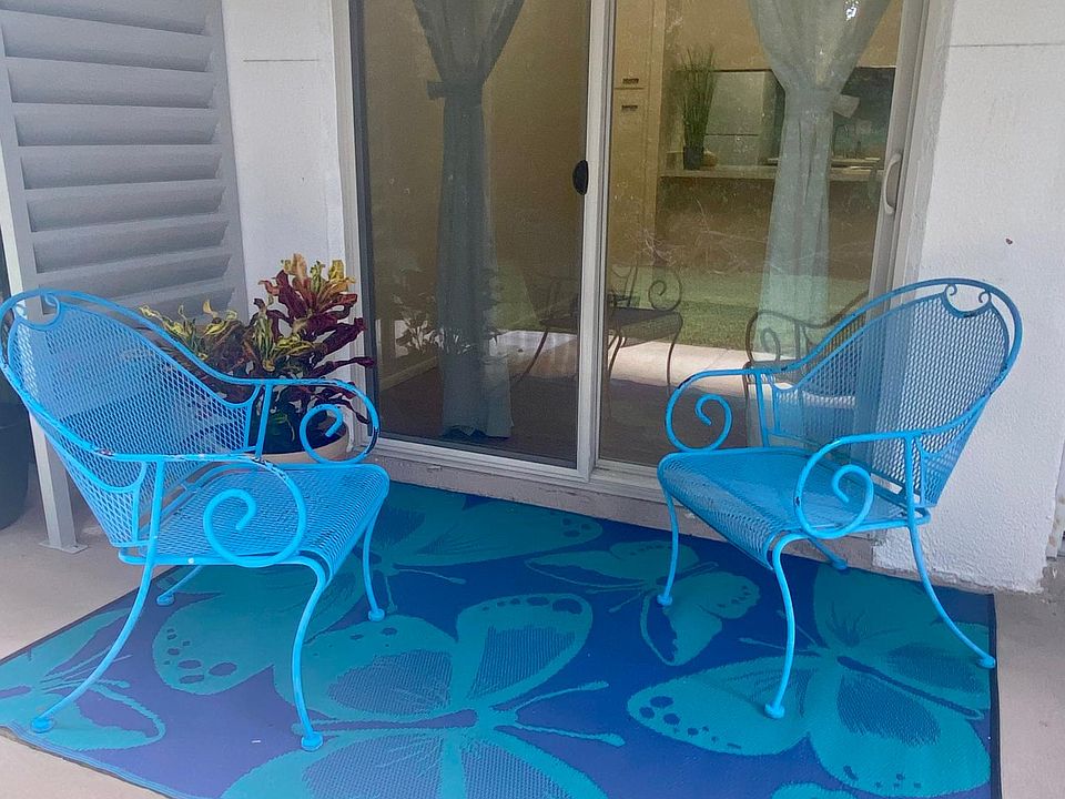 Patio porch with double glass slider, perfect for morning coffee. Condo location is very private, with quiet green space views and mature landscaping.