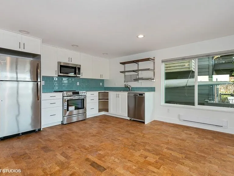 Kitchen with all new Frigidaire appliances, Quartz countertops, and glass tile backsplash