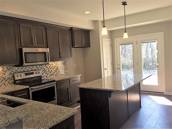 Covered patio off kitchen, grills allowed.