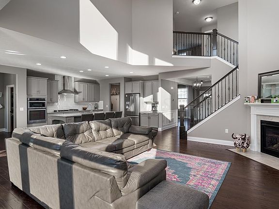 Large 2 story Great Room in Neutral colors with hardwood floring