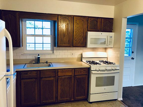 Eat In Kitchen: new appliances: Stove, microwave, dishwasher, refrigerator. Back door to deck and dining room to right.