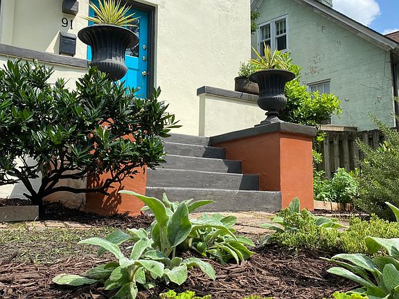 Front door to apartment, parking space to right.