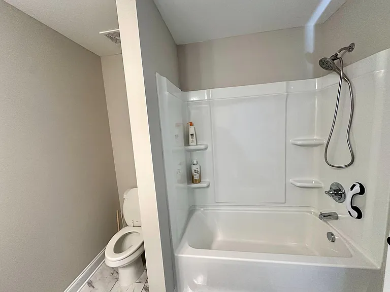 Bathtub and shower in shared bathroom