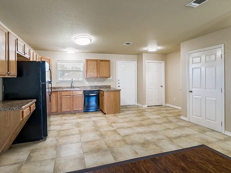The kitchen and entry of a Phase 2 apartment home at Gardens of DeCordova