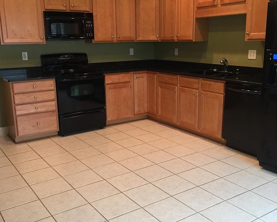Tile floors and granite countertops in kitchen.