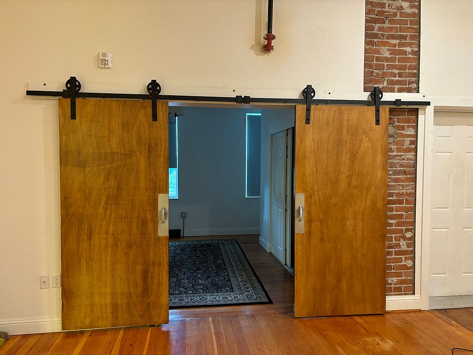 Original church doors leading into first bedroom