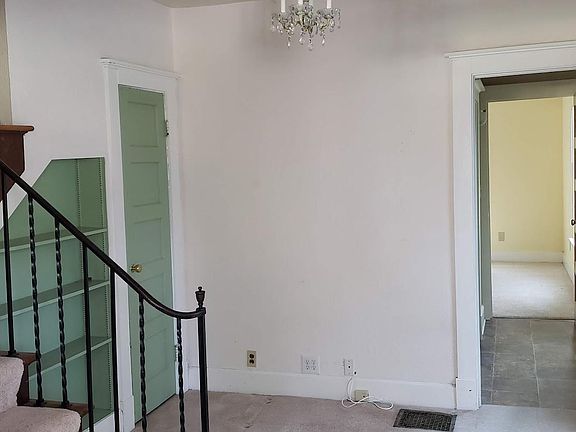 Stairs and landing area with built-in bookshelves and huge closet