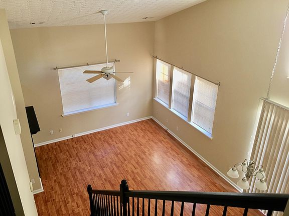 Open Living Room w/ Fireplace to Dining Room