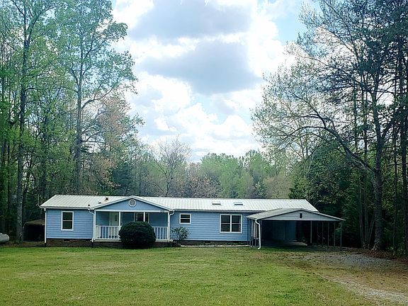 Large flat front yard, double carport and covered patio.