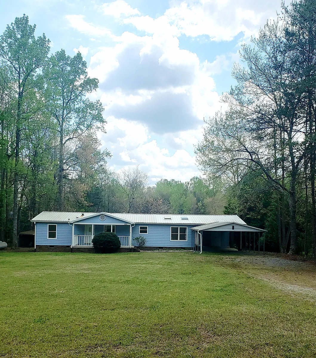 Photo 2 of 20 - 150 Navaho Trl - Rutherfordton, NC Large flat front yard, double carport and covered patio. - 150 Navaho Trl