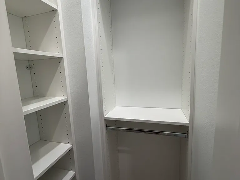 Downstairs storage off the hallway with shelving system