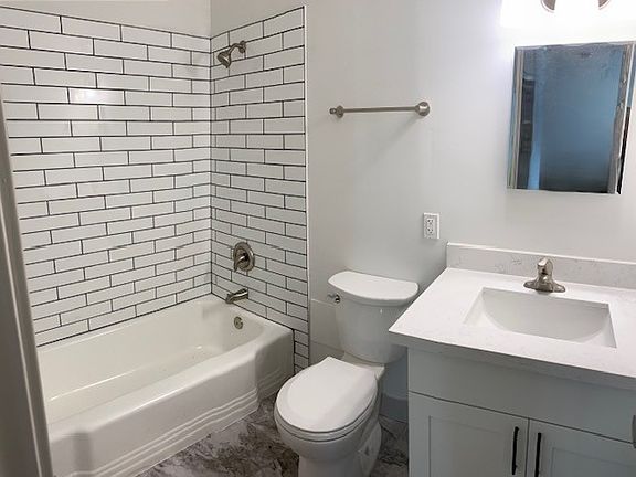 All new bath with ceramic tile shower surround, vinyl flooring, new plumbing fixtures and finishes.