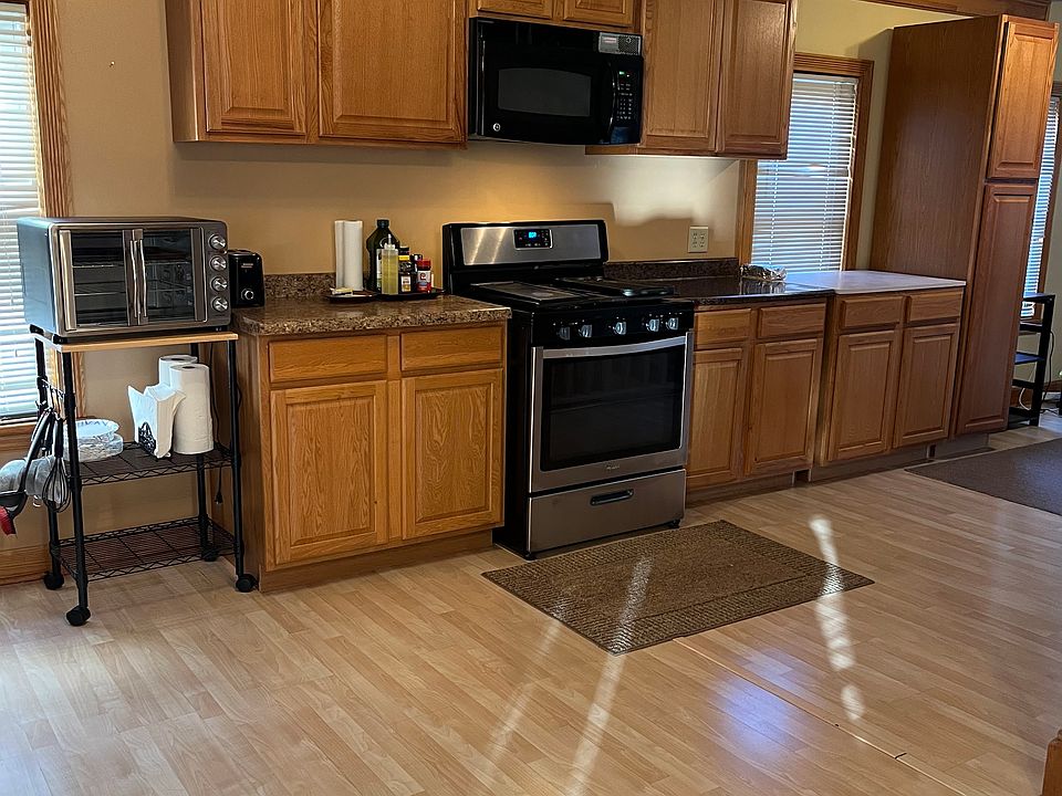 Stainless stove with microwave and hood; ample counter and cabinet space.